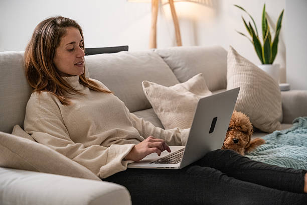 istock Woman working from home relaxing with dog 2248381644