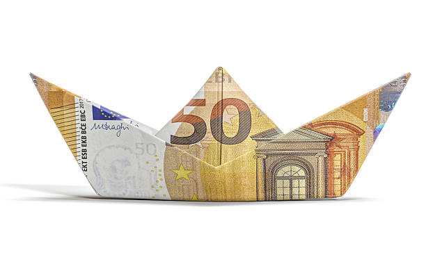 istock Euro banknote paper boat floating on white background 2248382279