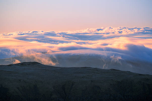 A cloud inversion seen from Helvellyn summit in The Lake District mountains, UK.