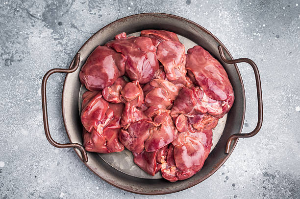 istock Raw poultry liver, chicken offals beautifully displayed, ready for seasoning. A nutritious ingredient ideal for gourmet dishes and traditional recipes. grey background. top view 2248383635