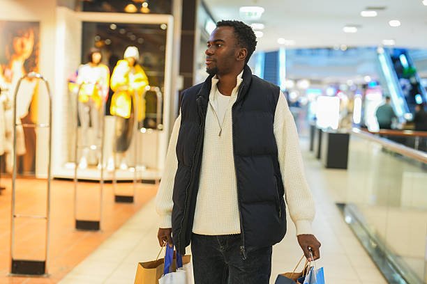 istock Confident Man Enjoying a Relaxed Shopping Day at the Mall 2248383640