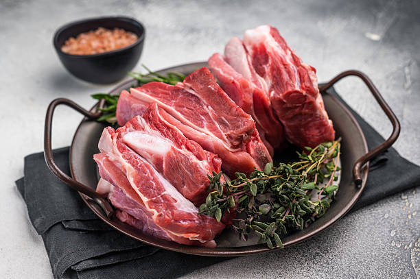 istock Raw lamb Riblets, fresh mutton meat with rib bone. grey background. top view 2248389411
