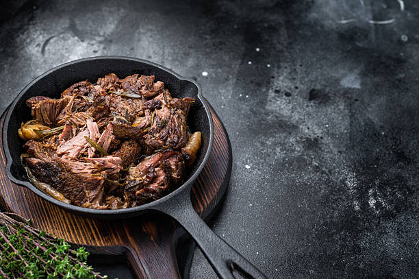 istock Beef bourguignon stew with tender beef in a pan. black background. top view 2248390336