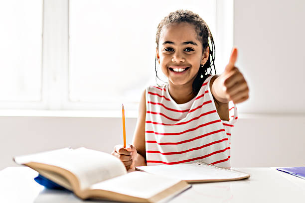istock A cute Black girl doing homework at home 2248391198