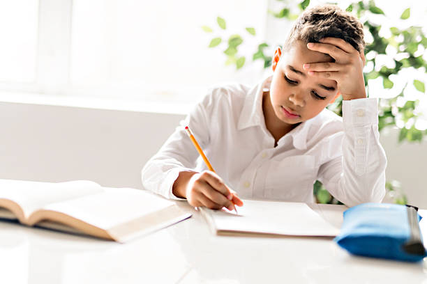 istock A cute Black boy doing homework at home 2248391264