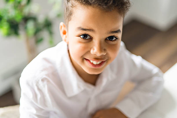 istock A cute Black boy doing homework at home 2248391281