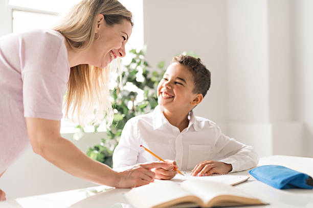 istock mother help Black boy doing homework at home 2248391414