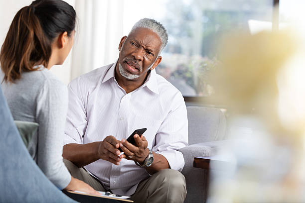 istock Therapist showing client something on smartphone during session for emotional support. 2248392939