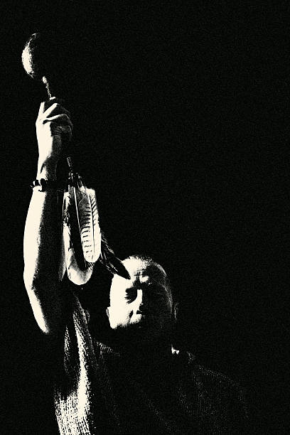 A ritual black-and-white portrait where a raised hand becomes a symbol of power, invocation, and spiritual presence. The image conveys strength, focus, and an archaic aura distilled into one powerful pose.