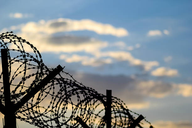 istock Barbed wire fence on the european border. 2248393442