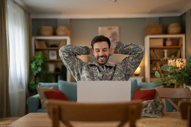 istock Military man video calling at home relaxing 2248394536