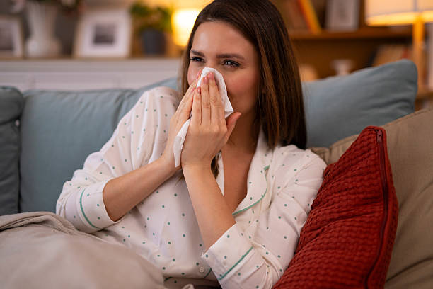 istock Woman blowing nose with tissue feeling sick 2248394588