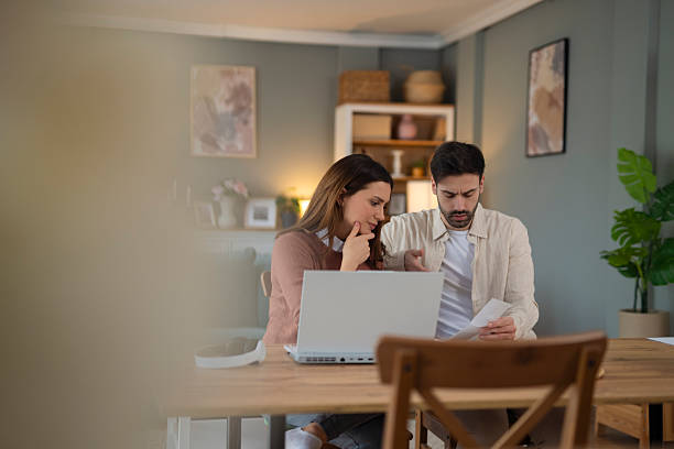 istock Young couple managing home finances and paying bills online 2248394730
