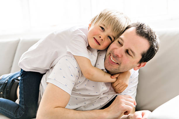 istock A Father and his five years kid on the sofa at home 2248395524
