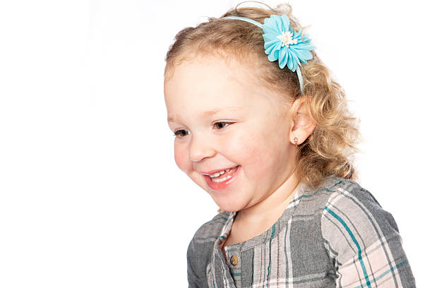 Cute little preschool girl with snowflake crown looking at the camera. Adorable happy child celebrating Christmas and winter holiday
