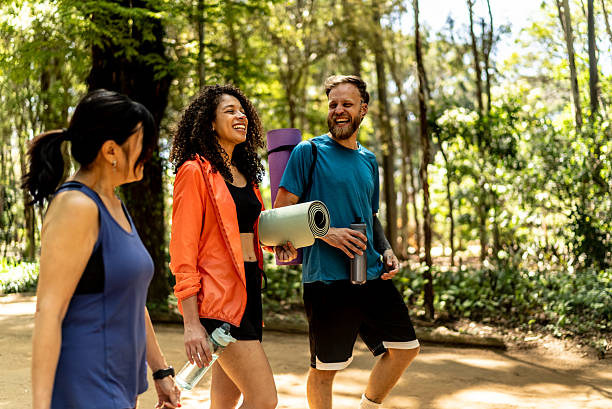 istock Friends walking and talking on the public park 2248398460