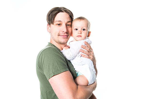 A Father holding small cute baby on studio white background