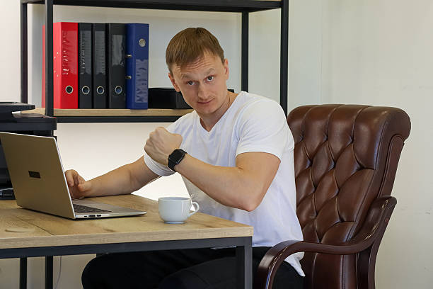 istock Determined man showing fist strength at workplace 2248399575