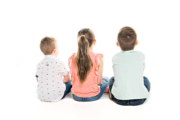 Adorable children sits on a park bench