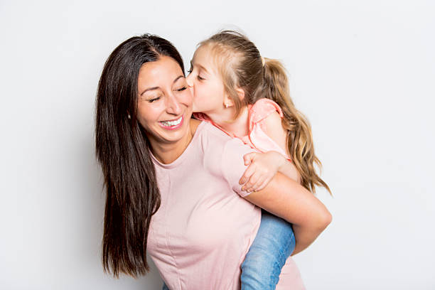 istock pretty mother standing with her cute daughter 2248400633