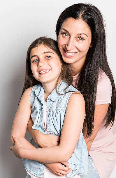 istock pretty mother standing with her cute daughter 2248400655