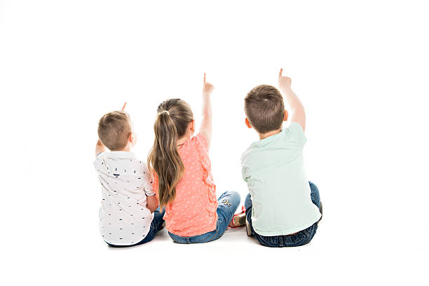 istock Back view of child group sitting on floor looking at wall 2248400742