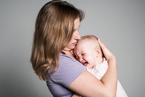 A Mother trying to calm her crying baby