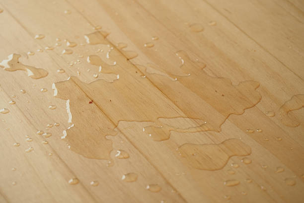 istock Water droplets on a wooden surface after a spill 2248401191
