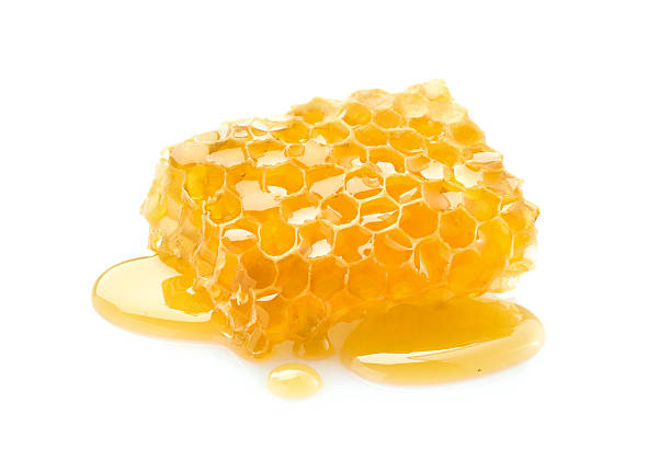istock Honeycomb with honey drop on white background 2248403496