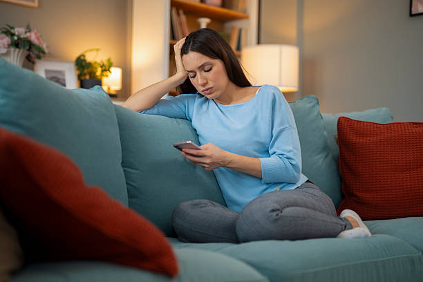 istock Woman feeling stressed scrolling phone at home 2248404061
