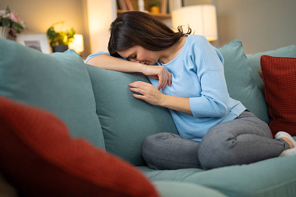 istock Woman feeling sad, tired, and alone at home 2248404065