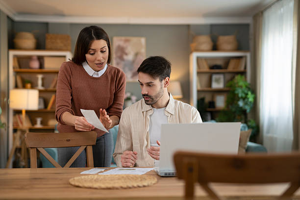 istock Couple arguing about budgets and finances at home 2248404133