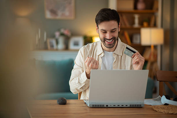 istock Happy man successfully making online payment with credit card 2248404150