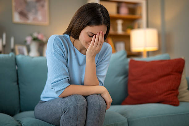 istock Unhappy woman sitting on sofa feeling sad and depressed 2248404151