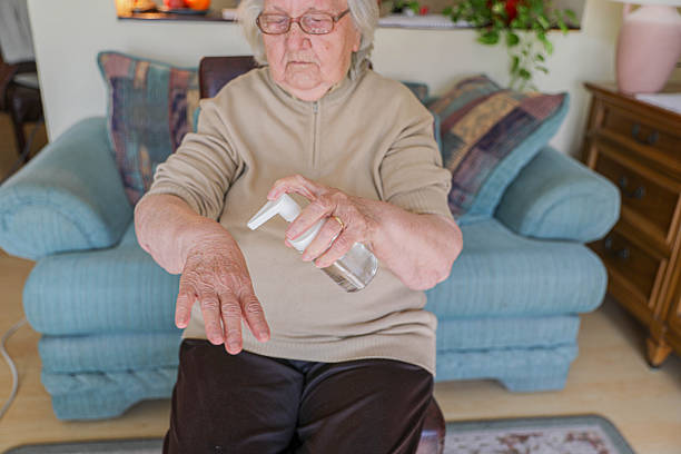 istock Senior Woman 80+ Using Hand Sanitizer At Home 2248404899