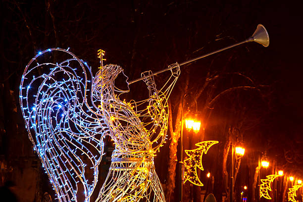 istock Holiday angel sculpture illuminated during evening celebration at city park pathway 2248405006