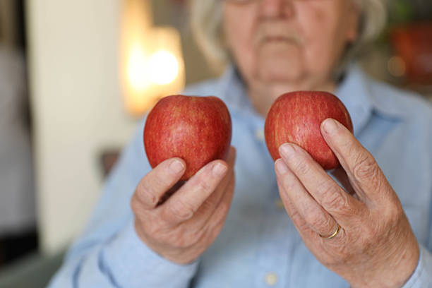 istock Older Woman Considering Healthy Fruit Selection Indoors 2248405007