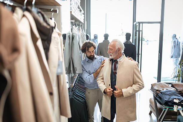 istock Cheerful Senior Shopper Receiving Help in Boutique Store 2248405132