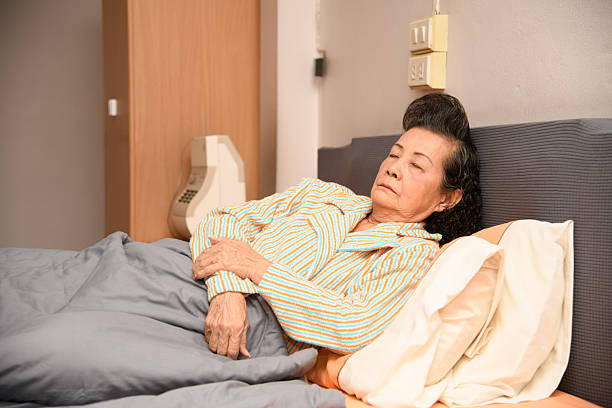 istock An old woman is sleeping on the bed 2248406053