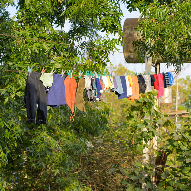 Clothes hanging on a line outside a rustic village house, capturing daily rural life and sunlight on fabric.