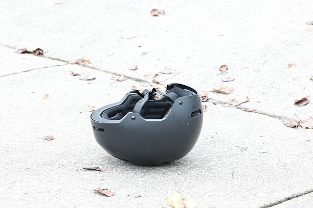 istock Black helmet placed on a light concrete ground with soft natural lighting. 2248409523