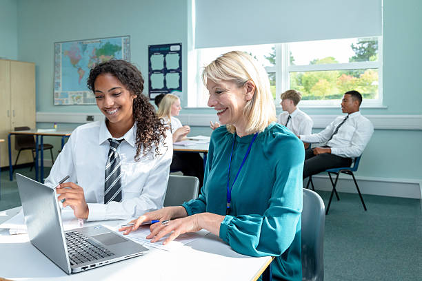 istock A teacher providing one-to-one support to a high school student using a laptop in the classroom 2248409597