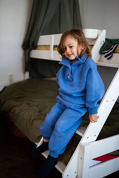 istock Toddler child sitting on bunk bed ladder 2248412567
