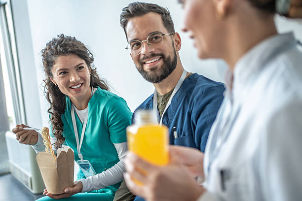 istock Medical staff enjoying lunch break together 2248412722