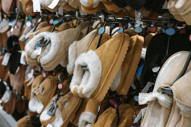 Cozy sheepskin slippers displayed in store with various color options.