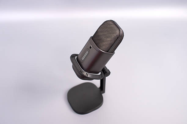 istock Black metal microphone on stand with minimalist background 2248413642