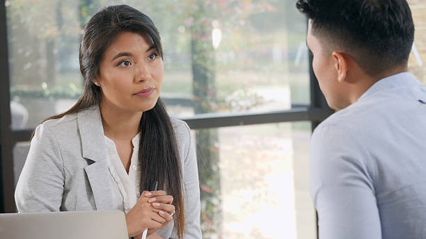 istock Two professionals engaged in a serious conversation in an office meeting. 2248414704