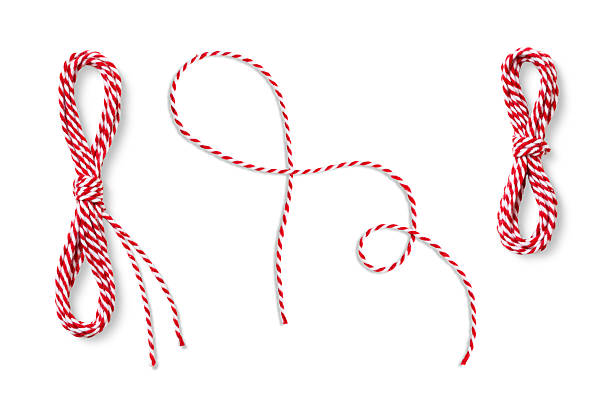Twisted red and white string arranged in different loops and tied shapes, isolated on a white background. High-resolution cutout perfect for Christmas design projects and craft materials.