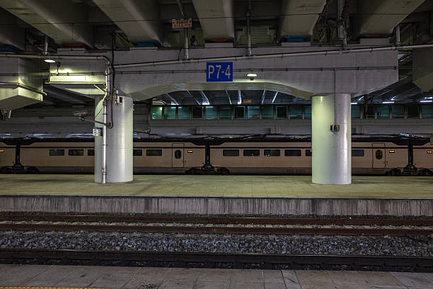 istock Passenger train at an illuminated underground station platform, empty modern metro scene ready for departure at night 2248415499
