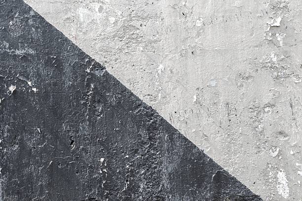 Grunge diagonal pattern in gray, black tones with concrete texture. Industrial aesthetic, worn surface. Background, texture, pattern for modern digital art, web design, urban visuals.